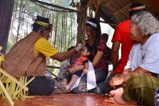 Carey Island, Selangor/Malaysia - Mar 17 2018: Malaysia aborigine Mah Meri with mask at oil palm estate, Mah Mei cultural ritual during Hari Moyang at wooden hut.