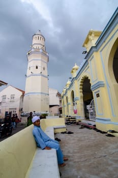 George Town, Penang/Malaysia - Jul 19 2018: Muslim kid sit outside Acheh Mosque.