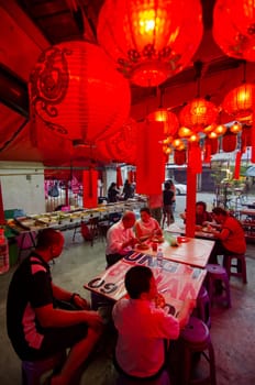 George Town, Penang/Malaysia - Jul 31 2018: Chinese people eat vegetarian food at temple decorated with red lantern.