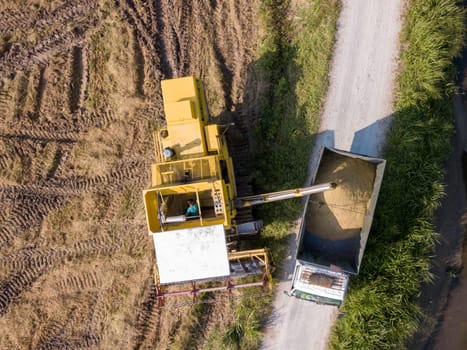 Bukit Mertajam, Penang/Malaysia - Apr 19 2019: Aerial view harvester and truck at paddy field.