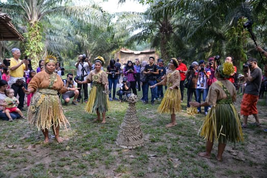 Carey Island, Selangor/Malaysia - Mar 17 2018: Malaysia aborigines Mah Meri dance in front of tourists.