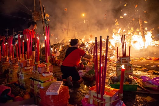 Bukit Mertajam, Penang/Malaysia - Aug 17 2019: Chinese devotees pray with joss paper and stick during hungry ghost festival.