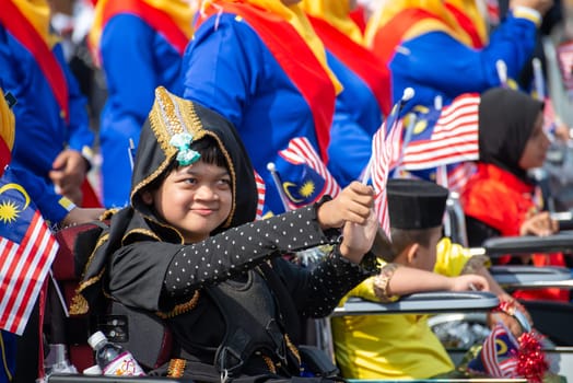 Butterworth, Penang/Malaysia - Aug 31 2019: Kids waving Malaysia flag during Merdeka parade.