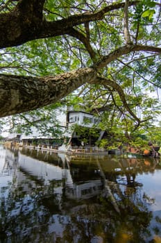 Tanjung Tualang, Perak/Malaysia - Oct 07 2019: Tin Dredge No. 5 reflection in water around green trees.