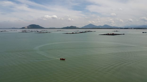 Pulau Aman, Penang/Malaysia - Oct 19 2019: Fishing boat move at fishing farm.