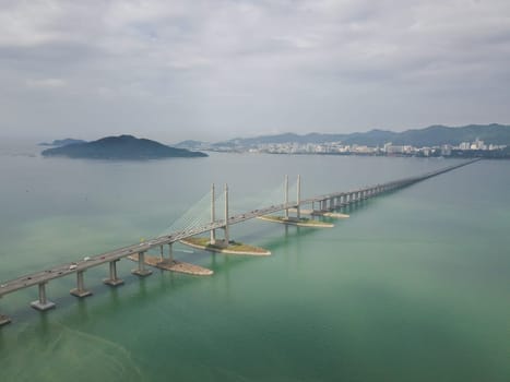 George Town, Penang/Malaysia - Oct 24 2019: George Town, Penang/Malaysia - Oct 24 2019: Aerial view Penang Bridge with island at background.