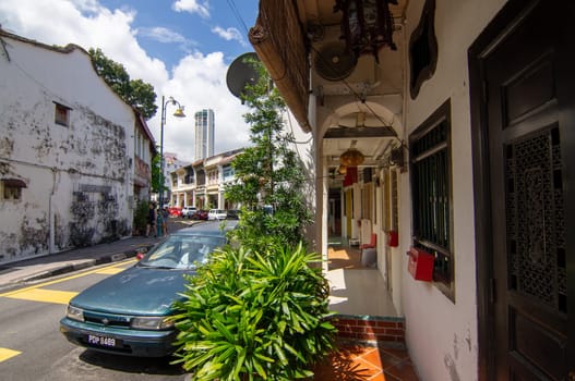 George Town, Penang/Malaysia - Nov 11 2019: An old heritage house at Lebuh Armenian. Background is KOMTAR building.