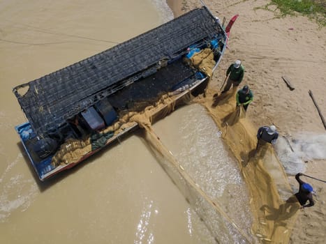 Penaga, Penang/Malaysia - Oct 27 2019: Aerial view fisherman cleaning the net near beach.