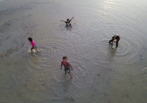 Penaga, Penang/Malaysia - Nov 03 2019: Asian Malays children play muddy in paddy field.