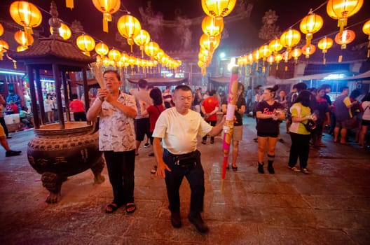 Georgetown, Penang/Malaysia - Jan 24 2020: Chinese pray with joss stick during first night of Chinese New Year.