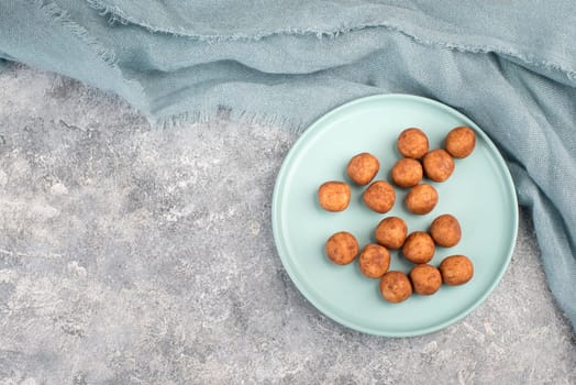 Marzipan potatoes, in german called Marzipankartoffeln, with cacao powder, sweets for christmas, empty copy space