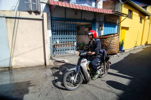 Bukit Mertajam, Penang/Malaysia - Jan 05 2020: A man ride the motor carry with big basket.