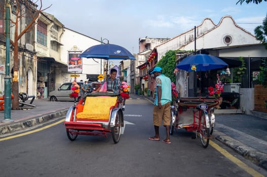 Georgetown, Penang/Malaysia - Feb 14 2020: Rickshaw driver at Armenian Street.