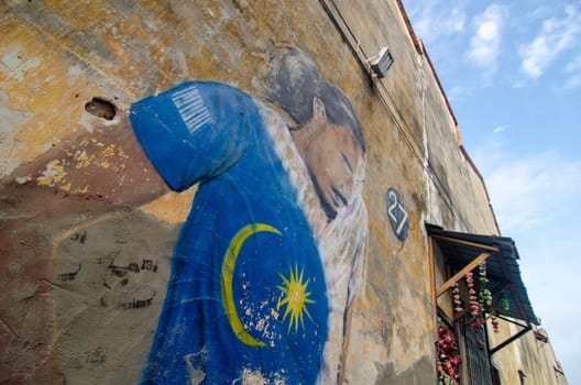 Georgetown, Penang/Malaysia - Feb 14 2020: Street mural art a man wear Malaysia logo shirt