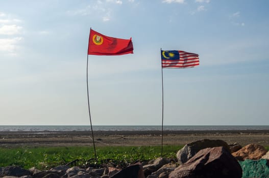 Pulau Sayak, Kedah/Malaysia - Feb 26 2020: Malaysia and Kedah flag waving near outdoor.