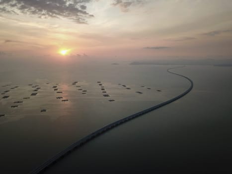 Batu Kawan, Penang/Malaysia - Feb 27 2020: Aerial view Sultan Abdul Halim Muadzam Shah Bridge in sunset near fish far