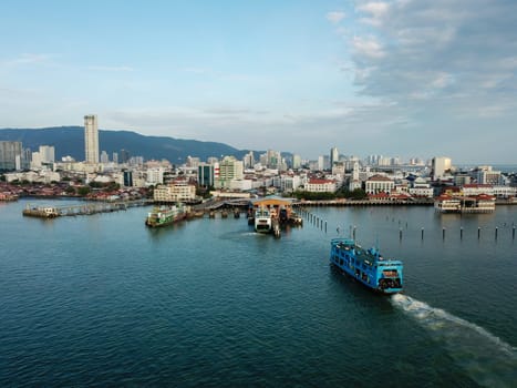 Georgetown, Penang/Malaysia - Feb 28 2020: Blue ferry carry passenger move towards Georgetown.
