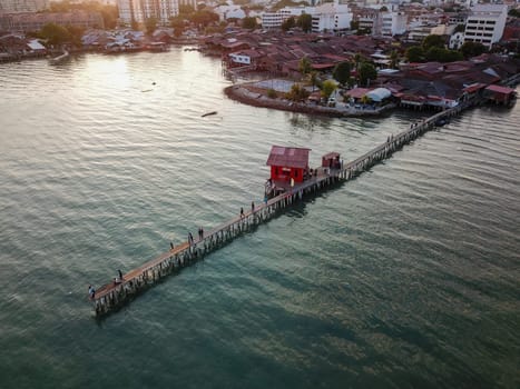 Georgetown, Penang/Malaysia - Feb 28 2020: Aerial view Tan Jetty with red temple during sunset.