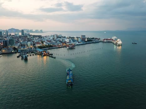 Georgetown, Penang/Malaysia - Feb 28 2020: Aerial view blue ferry leave terminal Georgetown at night.