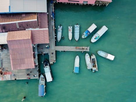 Georgetown, Penang/Malaysia - Feb 28 2020: Aerial view boats anchor at wooden house at sea.