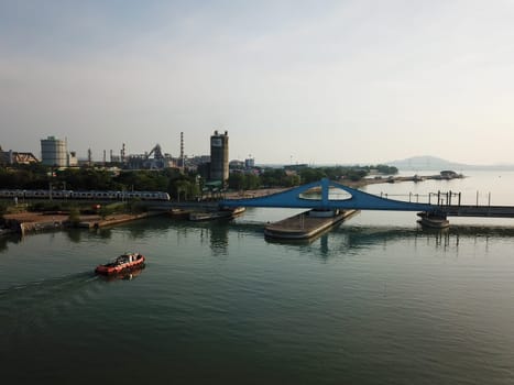 Perai, Penang/Malaysia - Mar 02 2020: A tugboat is move toward Prai River Swing Bridge