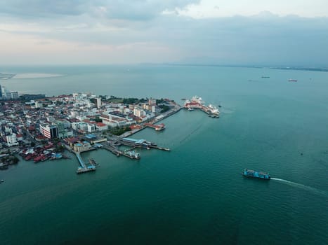 Georgetown, Penang/Malaysia - Feb 28 2020: Aerial blue ferry move toward Penang Island.