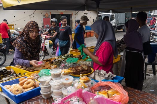 Malays cake seller at market.