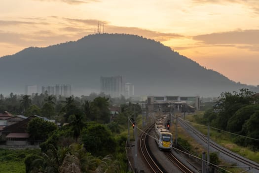 Bukit Mertajam, Penang/Malaysia - Mar 08 2020: A train move from train station. Background is hill.