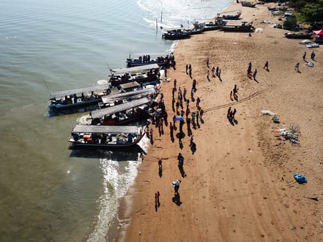 Crowd come to the jetty buy fish.