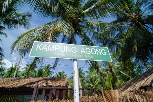 Penaga, Penang/Malaysia - Mar 15 2020: Kampung Agong signboard in coconut farm.