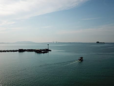 Georgetown, Penang/Malaysia - Mar 17 2020: Fishing boat move toward Penang Bridge.
