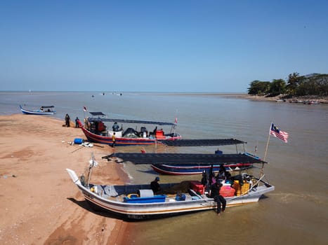 Penaga, Penang/Malaysia - Mar 14 2020: A boat with Malaysia flag park at coastal.