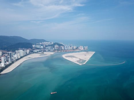 Georgetown, Penang/Malaysia - Mar 17 2020: Aerial view a ship at reclamation land near Gurney.