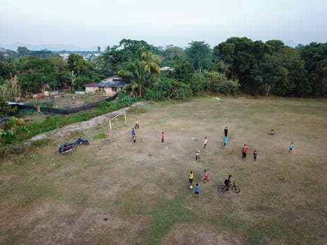 Seberang Perai, Penang/Malaysia - Mar 20 2020: Local kids play in football field.