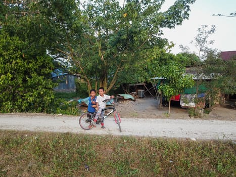 Seberang Perai, Penang/Malaysia - Mar 20 2020: Malays kid cycle at kampung.