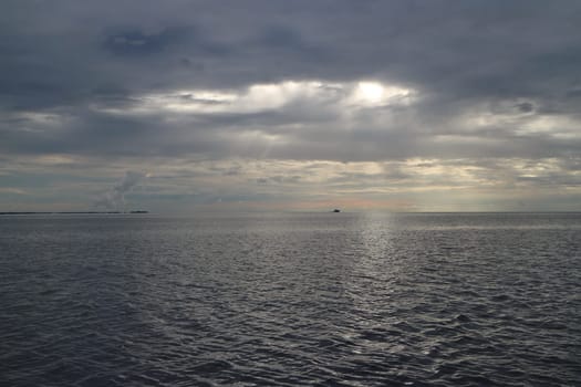 dramatic seascape heavy black clouds obscure the sun