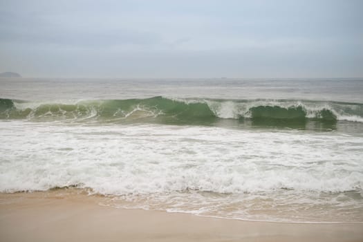 Ocean surf on the beach of Copacabana. Rio de Janeiro, February 2020