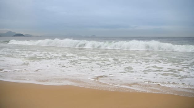 Ocean surf on the beach of Copacabana. Rio de Janeiro, February 2020