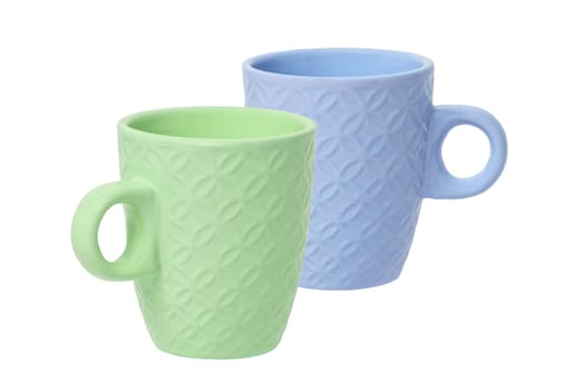 Mug of coffee. Closeup of a green and a blue ceramic mug or tea cup isolated on a white background. Macro.