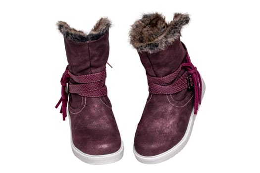 Winter shoes isolated. Close-up of a pair elegant violet suede leather winter boots and lined with brown fur. Girls winter shoe fashion new trends isolated on a white background. Macro photograph.