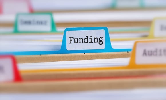 File folders with a tab labeled Funding