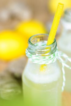 Cool lemonade with ginger, lime and lemon in a small bottle