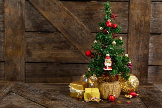 Little decorated Christmas tree with little presents