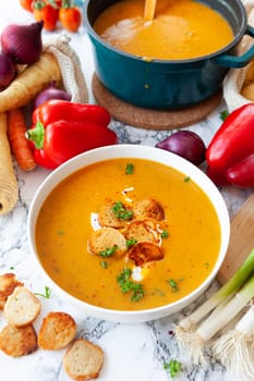 Bowl of hearty potato soup with fresh vegetables