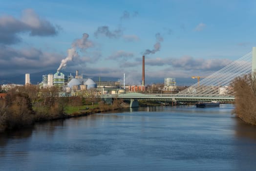 Barge in front of industrial plants on the main river in frankfurt hoechst, Germany