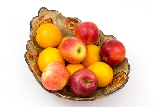 fresh fruits in a clay bowl - oranges and apples