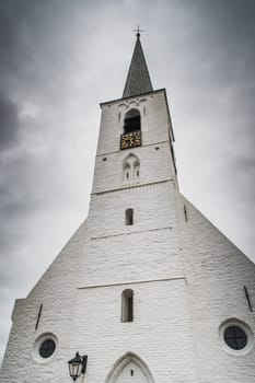 White church in Noordwijkerhout in the Netherlands with cloudy sky