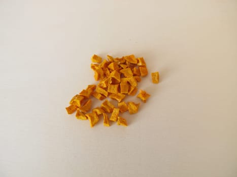 Dried turmeric, curcuma root on a wooden board