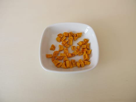 Dried turmeric, curcuma root on a wooden board