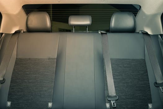 Rear Car Interior Including Gray Car Rear Seat and Rear Window and Safety Belt or Seat Belt in Vintage Tone